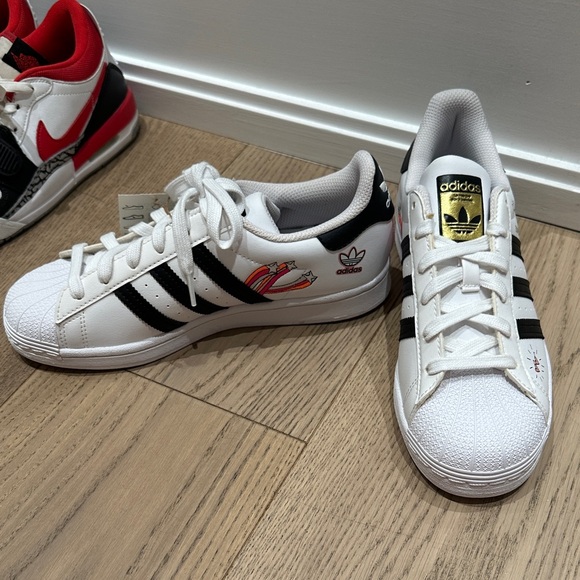 adidas Shoes - Adidas SuperStar J White Sneakers with Black Stripes and Gold Logo